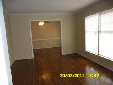 FORMAL LIVING ROOM WITH HARDWOOD FLOORS.  THERE IS
