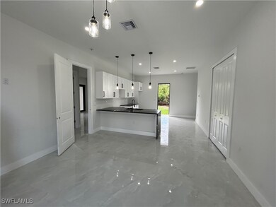 Kitchen featuring dark countertops, open floor pla