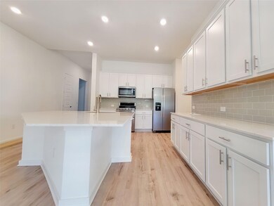 Kitchen featuring appliances with stainless steel