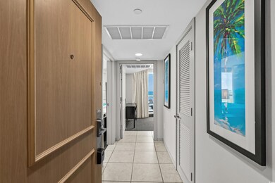 Hall featuring visible vents and light tile patter