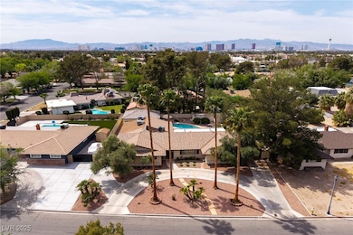 View of urban area featuring mountains and a pool