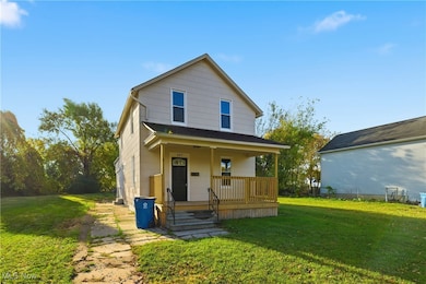 View of front of home with a front yard and a porch