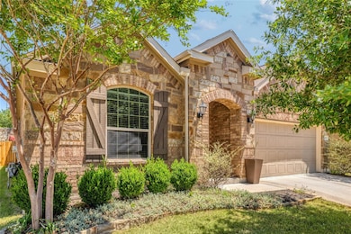 Traditional home featuring concrete driveway, sto
