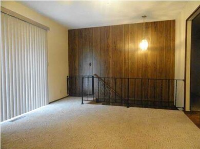 DINING AREA WITH STAIRCASE TO BASEMENT. SLIDING GL