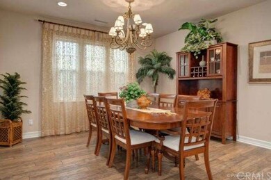 Spacious formal dinng room w/custom window drapes,