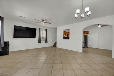 Unfurnished living room with ceiling fan, a chande