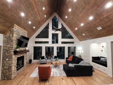 Living room with light wood-type flooring, high va