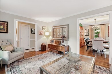 Living room with wood finished floors, a chandelie