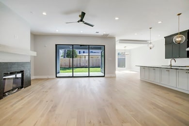 The family room is open to the kitchen and dining, and it features a sliding window wall.