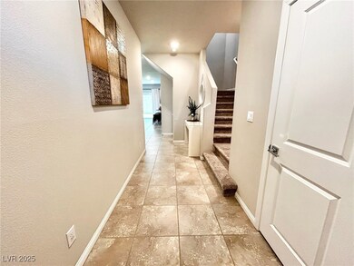 Hall with stairs, baseboards, and light tile patte