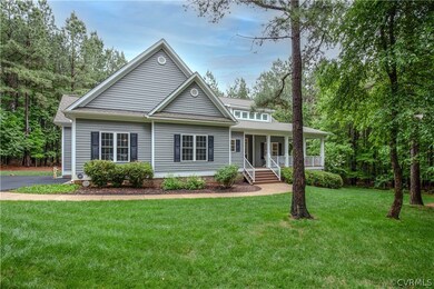 View of front of property featuring a porch and a front yard