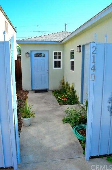 Iron gate entry from driveway to front courtyard, 