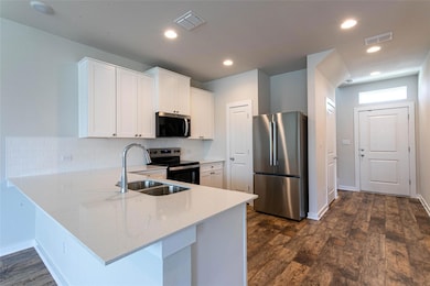 Kitchen with stainless steel appliances, a penins