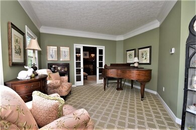 Living room with crown molding and glass french do
