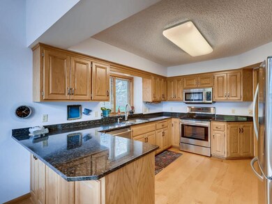 Kitchen has maple floors, and granite countertops