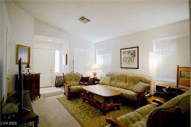 Living area with vaulted ceiling and carpet floori