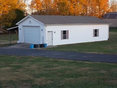 Detached garage with attached awning.  This building has concrete flooring and electricity.