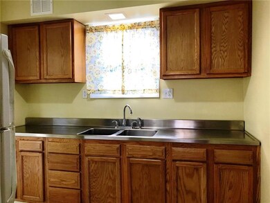 The galley style kitchen features oak cabinets and