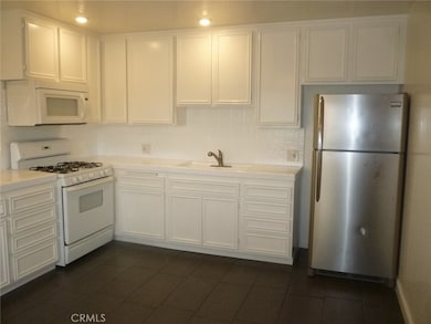 Gas range, refrigerator and microwave oven with hood are all included.  Again, notice the abundance of storage space in this large kitchen.