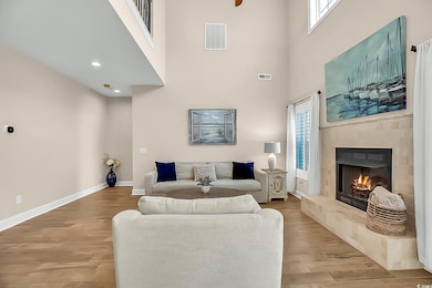 Living area with a tiled fireplace, visible vents,
