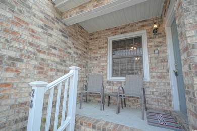 View of exterior entry featuring brick siding