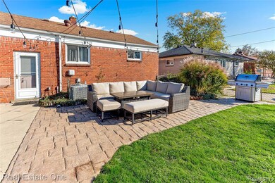 Back of house featuring a patio area, an outdoor hangout area, a yard, and brick siding