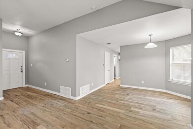 Entryway with visible vents, baseboards, and light