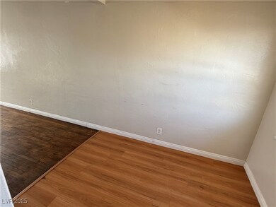 Spare room with baseboards and wood finished floor