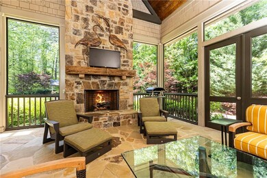Comfortable screened porch with stacked stone fireplace