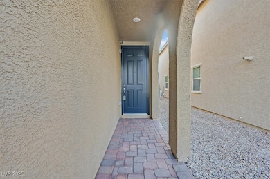 Doorway to property featuring stucco siding