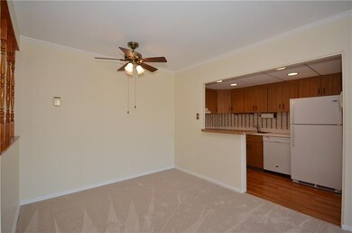 The dining room has a half wall opening to the kit