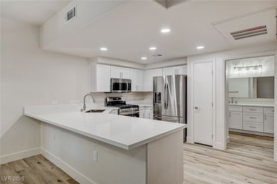 Kitchen with stainless steel appliances, a sink, l