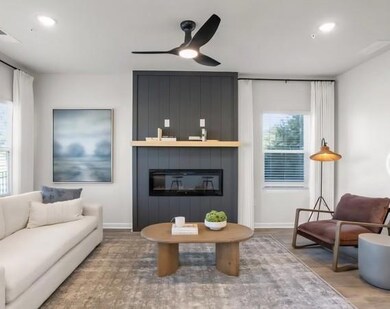 Living area with healthy amount of natural light, wood finished floors, a ceiling fan, and recessed lighting