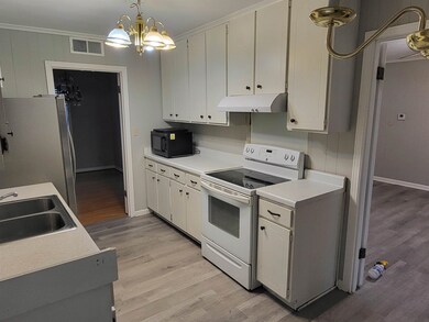 Kitchen featuring pendant lighting, white cabinets