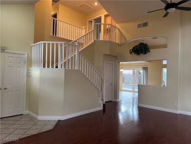 Stairs featuring wood finished floors, a towering