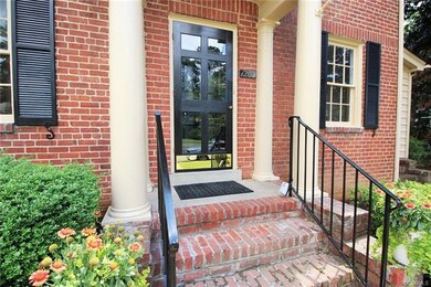 Classic Richmond storm door, new rails, lots of traditional column and beam detail, tuck-pointed brick steps