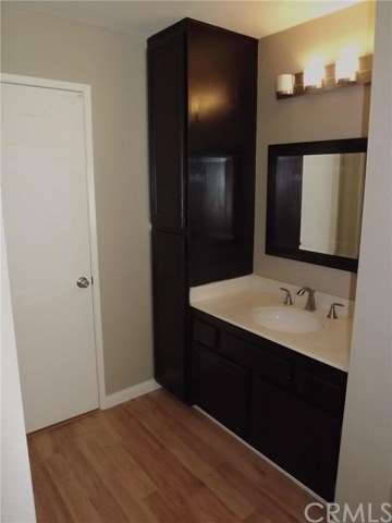 Master Bedroom has dark stained sink vanity, stora