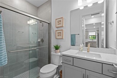 Full bath featuring a shower stall, toilet, and vanity