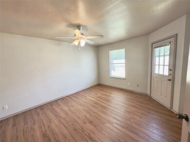 Unfurnished room featuring baseboards, ceiling fa