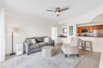 Living room featuring crown molding and ceiling fa
