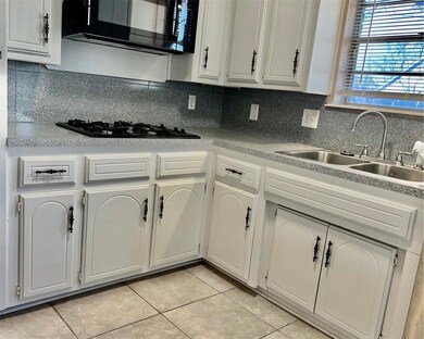 Kitchen featuring black appliances, tasteful backs