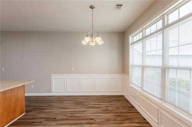 Unfurnished dining area with visible vents, dark w