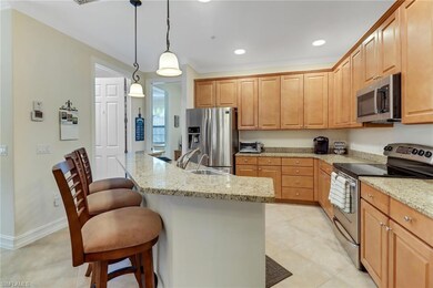 Kitchen with hanging light fixtures, a breakfast b