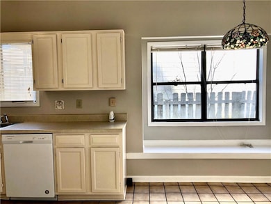 Kitchen featuring white dishwasher, pendant lighti