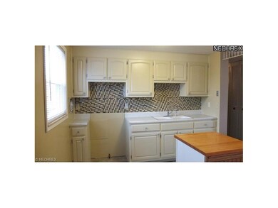 Kitchen with glass tile backsplash.