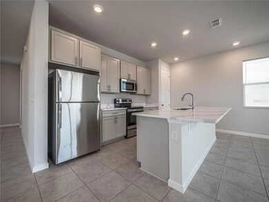 Open bright kitchen w/island - Stainless steel appliances, closet pantry
