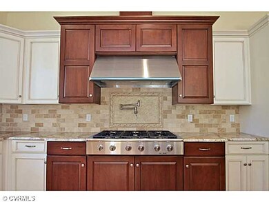 Kitchen - Nice DACOR commercial gas 6 burner cooktop with commercial hood and an Amazing pot filler faucet placed perfectly in the designer backsplash.  This home will certainly wow you!
