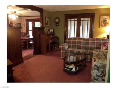 French doors to 3-season sunroom off living room