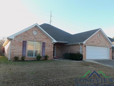 Ranch-style home featuring a front lawn and a gara