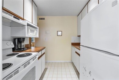 Kitchen featuring white cabinets, exhaust hood, an